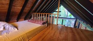 a bed in a room with a large window at Glamping Lagos de Venecia in Santa Rosa de Cabal