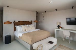 a bedroom with a bed and a tv and a chair at Euforia Retreat and Spa in Eforie Nord +153 photos