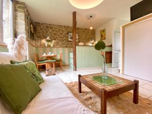 a living room with a couch and a table at Chambres d'Hôtes du Manoir du Haut Salmon in Saint Malo