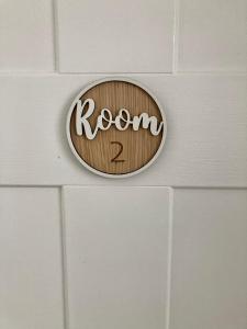 a wooden sign on a wall with the word room two at 8, St Marys , Private Double Ensuite Room - Room Only- Truro in Truro