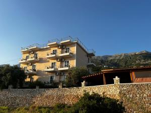 a building on top of a stone wall at Season Inn in Dhërmi