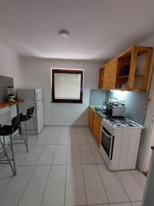 a kitchen with a stove and a counter top at Hostel Bobito in Sarajevo