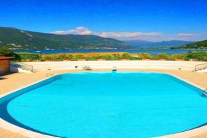 a large swimming pool with a view of the water at Copelia - Pool and Elegance in Paratico
