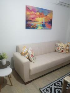 a couch in a living room with a painting on the wall at Argostoli Elia's Maisonette in Argostoli