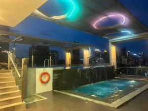 a rooftop swimming pool on a building with a city skyline at D Majestic Hosted By TCL Home 4141 in Kuala Lumpur