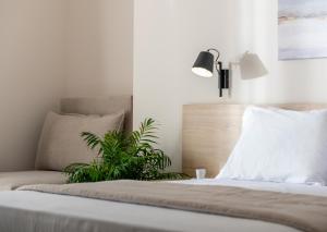 a bedroom with a bed with a plant on it at Calives Premium Stay in Kalivia Poligirou