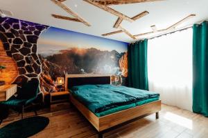 a bedroom with a giraffe mural on the wall at PARADiSE Wellness Residence - Sauna&SPA in Terchová