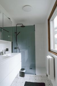 a bathroom with a shower and a sink at Imagine Tiny House 325 op Camping GT te Balen in Balen