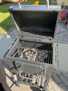 a grill sitting on top of a table at Vila v Brdech s bazénem, infra saunou a vybavením in Malá Víska