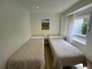 A bed or beds in a room at Acogedor Apartamento en zona privilegiada