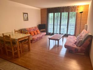 a living room with a couch and a table at Résidence « Les Crêtes » in Torgon