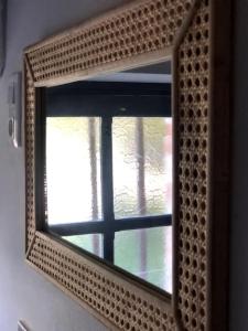 a mirror with a reflection of a window at La Petite Maison Dans la Nature in Forges
