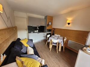 a living room with a couch and a table at Appartement Les Gets, 2 pièces, 4 personnes - FR-1-598-44 in Les Gets