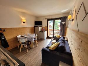 a living room with a couch and a table at Appartement Les Gets, 2 pièces, 4 personnes - FR-1-598-44 in Les Gets