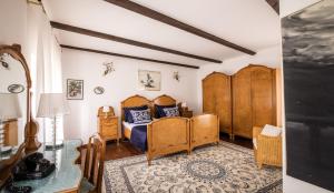 a bedroom with two beds and a table at Casa Rustica 1838 in Sovinjak