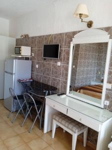 a bathroom with a mirror and a desk with a sink at Ionian residence in Argostoli