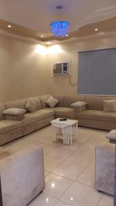 a living room with a couch and a screen at شاليه سحاب in Yanbu