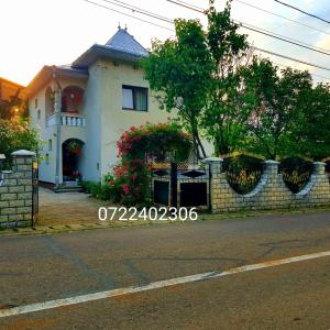 a white house with a fence in front of it at Casa Lucian in Pojorâta