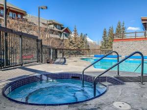 a large swimming pool with a hot tub at Spacious King Bed with Pool & Hot Tubs in Canmore