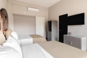 Postel nebo postele na pokoji v ubytování Hotel Rocaval San Cristóbal de las Casas