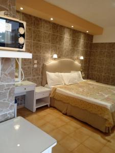 um quarto com uma cama e uma televisão em Ionian residence em Argostoli
