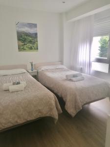A bed or beds in a room at Acogedor Apartamento en zona privilegiada