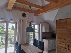 a kitchen with a wooden table and chairs and a window at Ferienwohnung Meyer Obergeschoss in Weißenburg in Bayern
