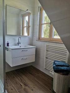 a bathroom with a sink and a mirror at Ferienwohnung Meyer Obergeschoss in Weißenburg in Bayern