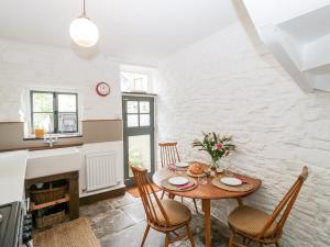 a kitchen and dining room with a table and chairs at 7 Bell Street in Talgarth
