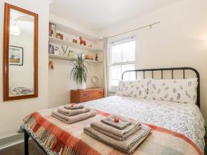 a bedroom with a bed with towels on it at 7 Bell Street in Talgarth