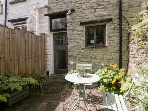 a small table in front of a stone house at 7 Bell Street in Talgarth
