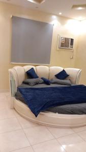 a large bed with blue pillows in a room at شاليه سحاب in Yanbu