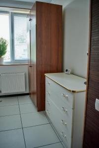 a kitchen with a counter and a dresser and a window at Vacation home Lubov in Kamianets-Podilskyi