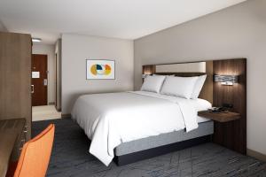 a hotel room with a large bed and a desk at Holiday Inn Express & Suites Alton St Louis Area, an IHG Hotel in Alton
