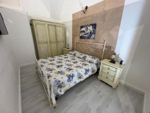 a small bedroom with a bed and a night stand at Cinzia’s Home in Lecce