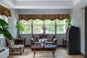 a living room with a couch and a table at Microtel Inn by Wyndham Spartanburg Duncan in Duncan