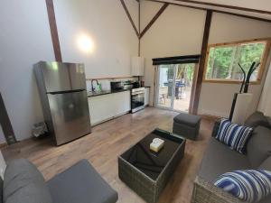 a living room with a couch and a refrigerator at Noah's Ark Campground in Revelstoke