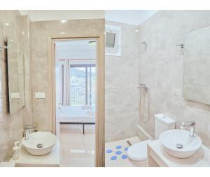 a bathroom with a sink and a toilet and a shower at Zanteapts 360 Gouzeli Apartment in Zakynthos Town