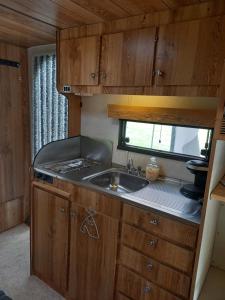 a kitchen with a sink and a counter top at Husvagn Öggestorp på Solberg Hults Camping in Ekshärad