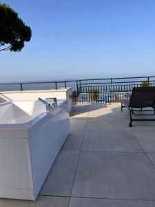 a balcony with a bench and a view of the ocean at Il Volo in Sperlonga