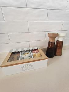 a box of food on a counter next to two bottles at La Puebla Rooms in Teror