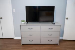 a dresser with a tv on top of it at Luxury 3BR Townhome in the Heart of Winston Salem NC - Sleep 6 in Winston-Salem