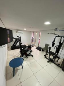 a gym with several treadmills and exercise bikes at Flat 402 Laguna Beach - tipo Loft encantador, mobiliado e aconchegante in Porto De Galinhas
