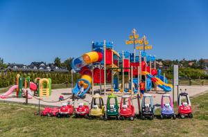 a playground with a bunch of toy cars on it at Domki Letniskowe Jastrzębia Park in Jastrzębia Góra +40 photos