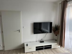a living room with a tv on a white wall at Beautiful 2 Bedroom Apartment in Prostějov