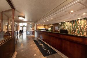 a lobby of a hotel with a bar in the middle at Oxford Suites Lancaster in Lancaster