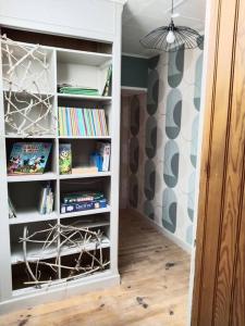 a book shelf filled with books in a room at Appartement chez LISA in Louvemont +3 photos