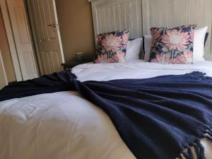 a bed with a blue blanket on top of it at Private Apartment for business and leisure Pretoria East in Pretoria