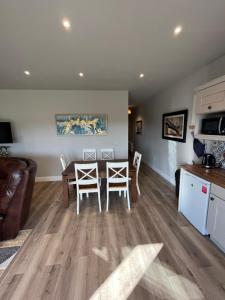 a kitchen and living room with a table and chairs at Knockreagh Farm Cottages Mountain or Cedar views in Kilkenny