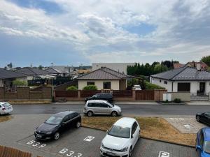 a group of cars parked in a parking lot at Beautiful 2 Bedroom Apartment in Prostějov